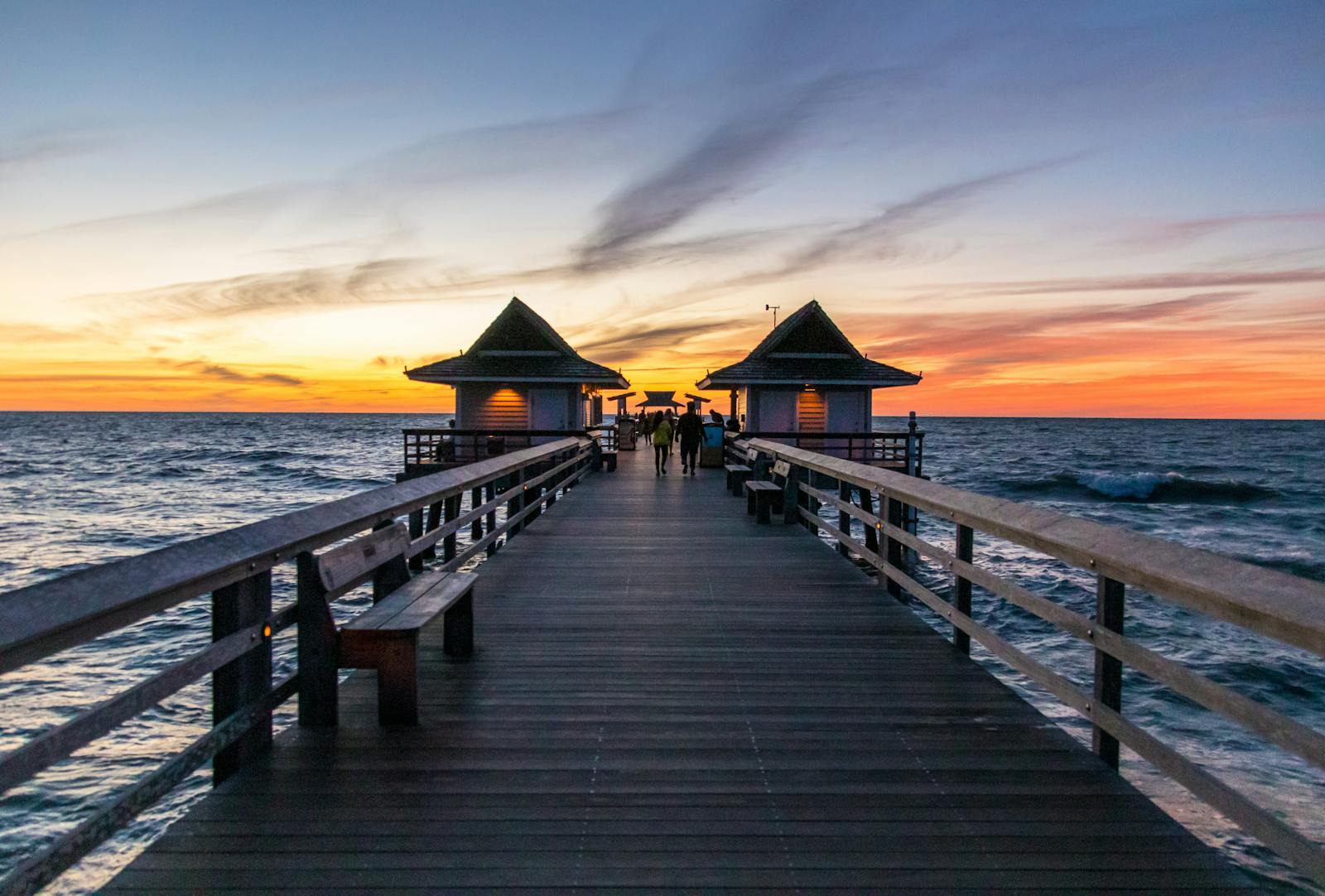Naples Pier extending into the Gulf of Mexico at golden hour, Collier County, Florida.