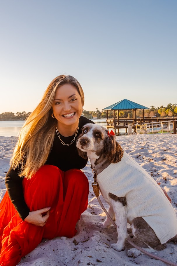 Lauren on a Southwest Florida beach with her dog at golden hour